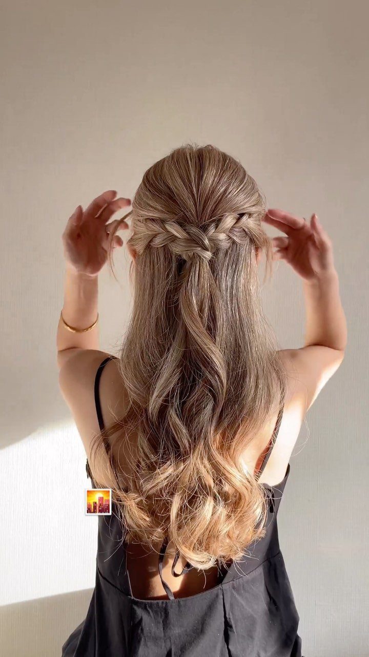 11 Half Up Half Down Wedding Hair Styles You'll Love 12 Woman with long blonde wavy hair in a half-up half-down braided wedding style.