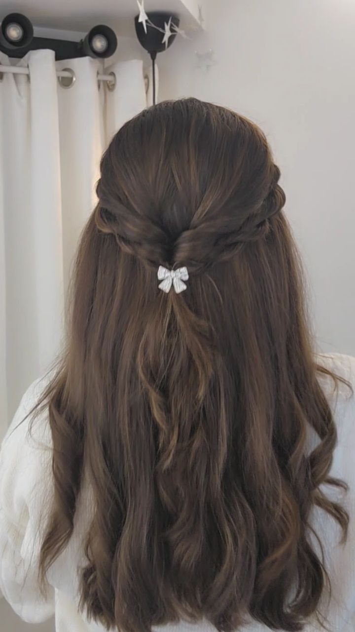 11 Half Up Half Down Wedding Hair Styles You'll Love 2 Long wavy brown hair in a soft twisted half updo with white bow.