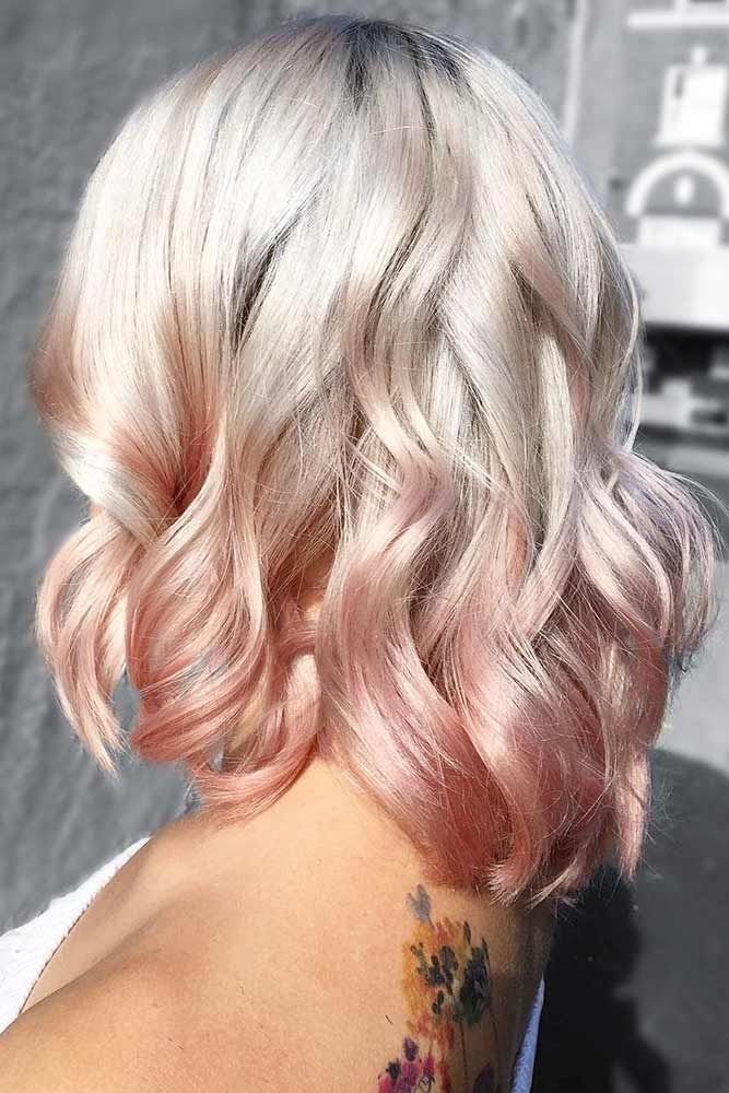 Blonde Hair with Rose Gold Highlights: 5 Ways to Wear It 4 Wavy hair transitioning from platinum blonde roots to rose gold pink ends on a person.