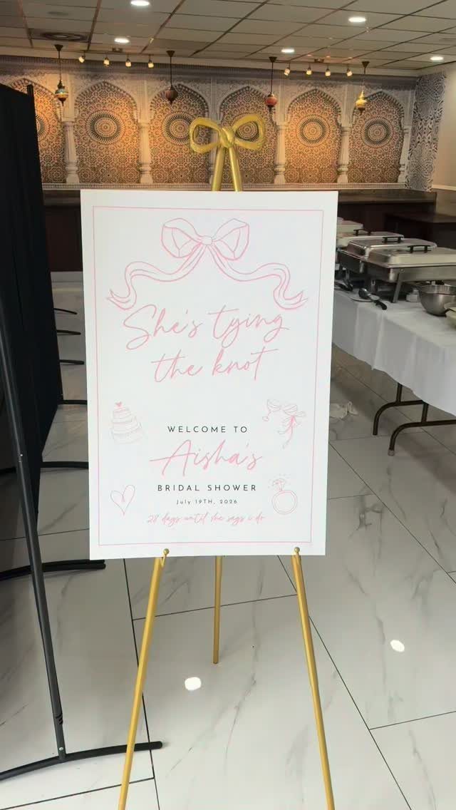 Welcome sign for a bridal shower on a gold easel stand