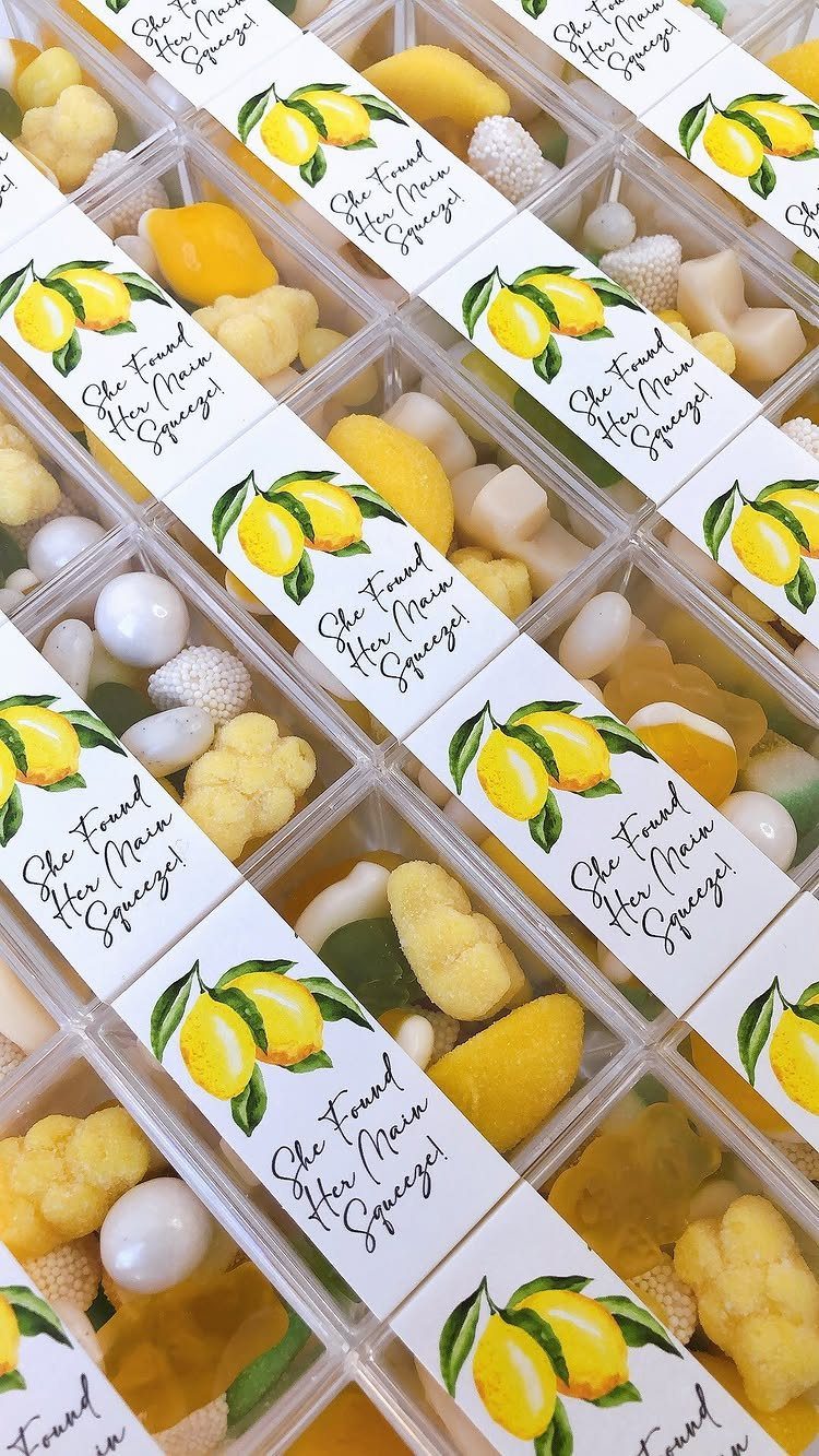 Yellow and white candies in clear boxes with lemon themed bridal labels.