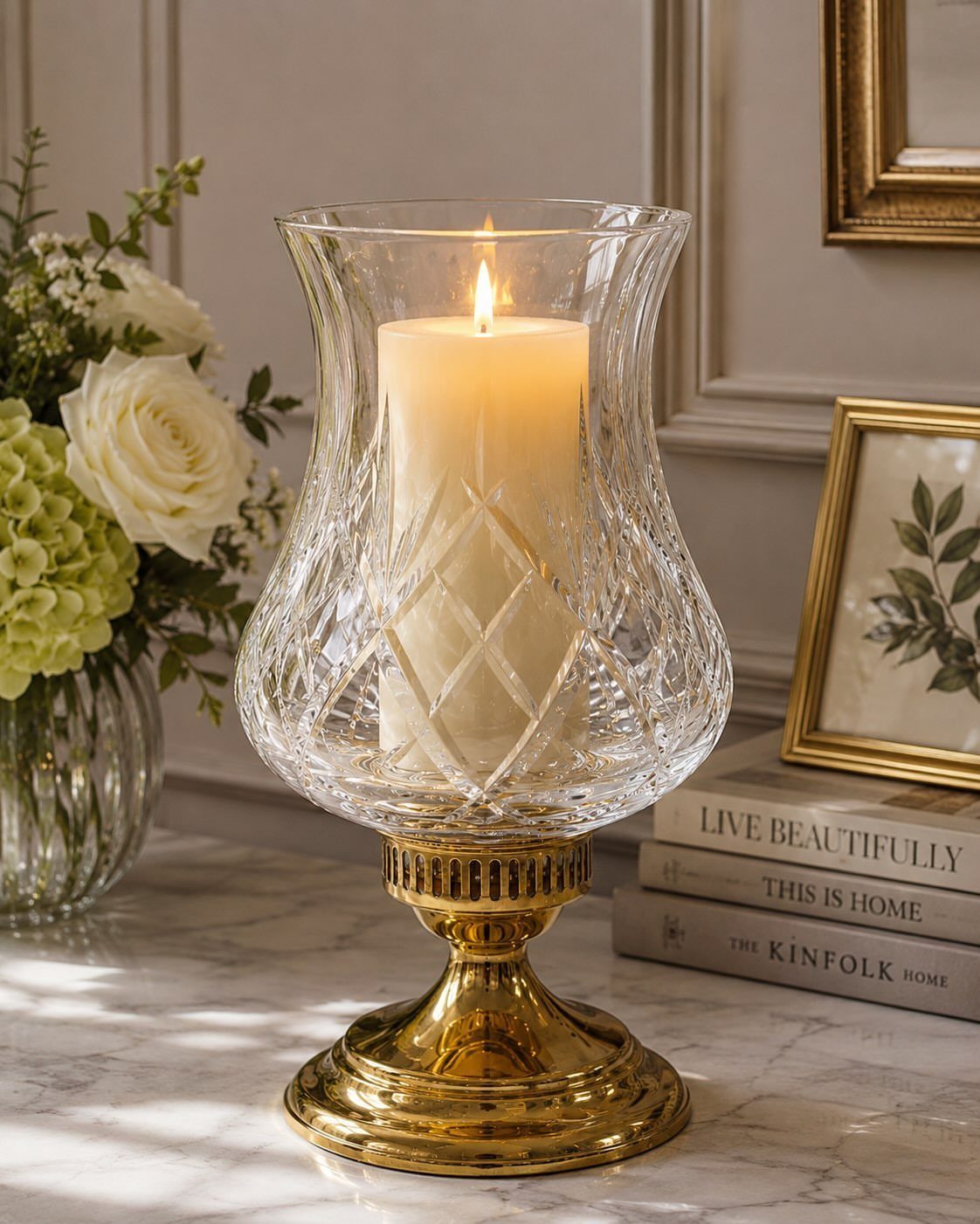 14 Candle Table Decor Ideas for Centerpieces That Feel Considered 14 Lit white pillar candle inside a patterned glass hurricane vase with a gold pedestal base.