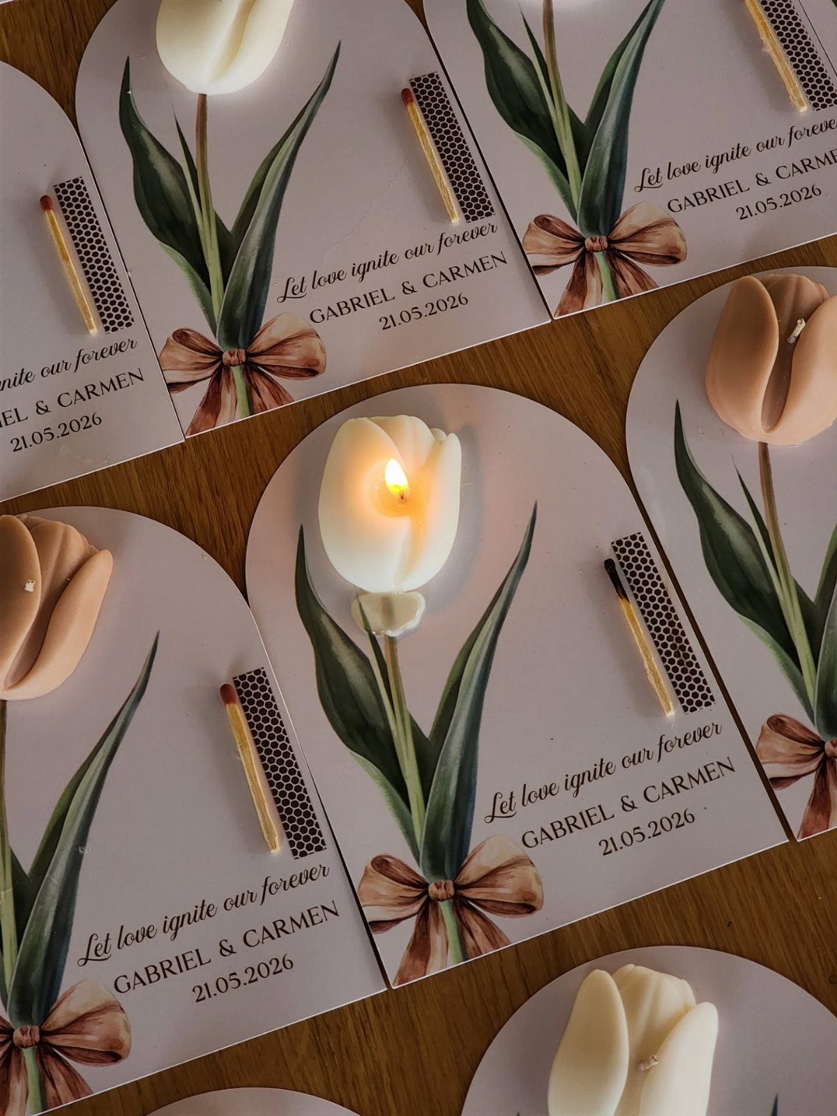9 Candle Wedding Favors: From Beach Gel to Flower-Topped Votives 8 Tulip-shaped candles attached to decorative wedding favor cards with matches and floral illustrations.