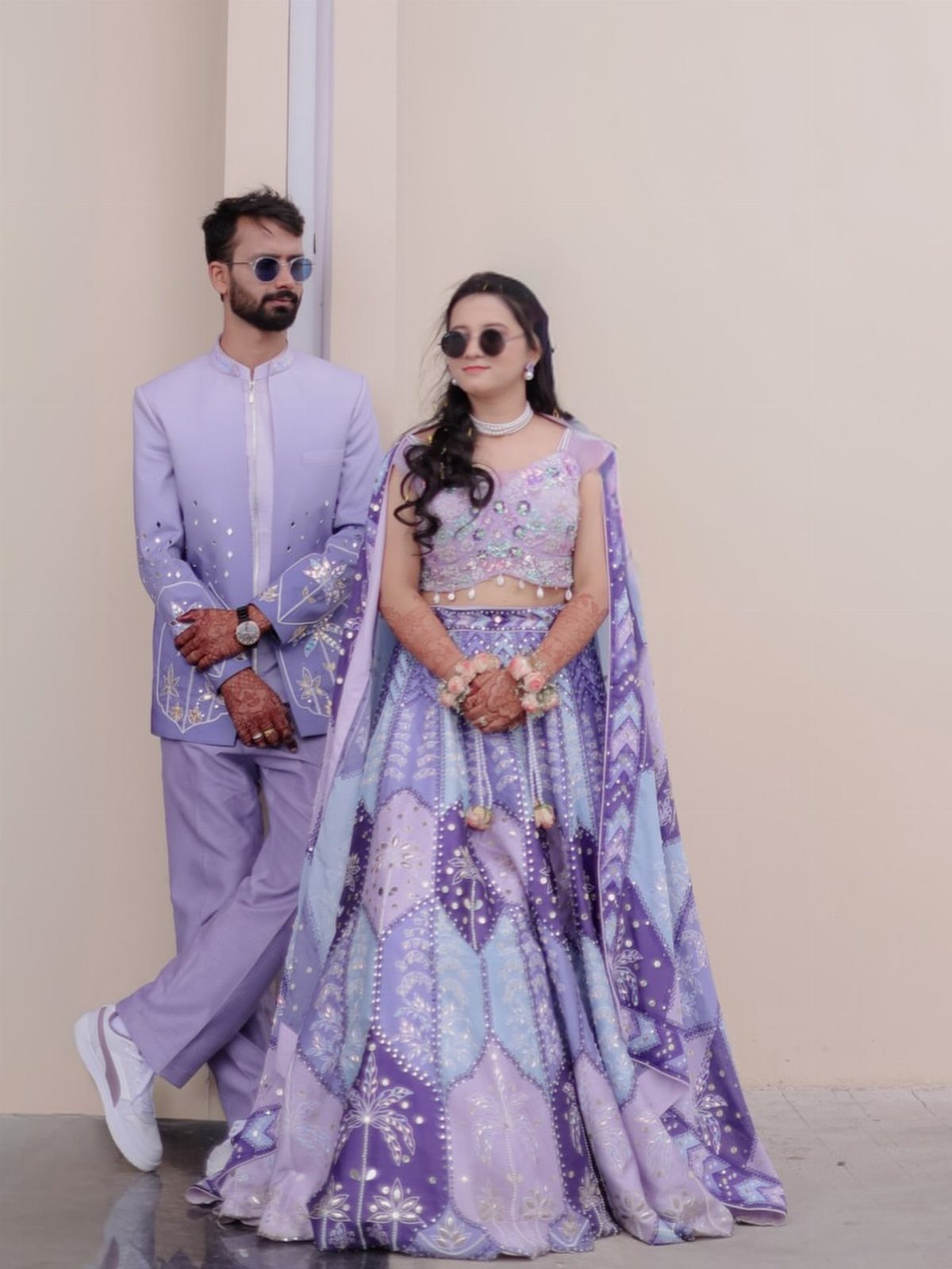 21 Color Combinations for Wedding Palettes in 2026 4 A man in a lavender suit and a woman in a lavender and aqua lehenga.