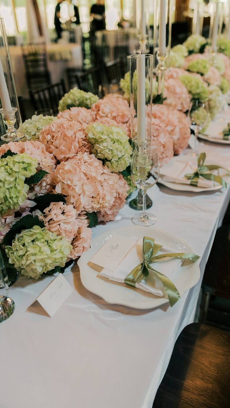 21 Color Combinations for Wedding Palettes in 2026 14 Pink and green hydrangeas arranged in a long floral runner on a wedding reception table.
