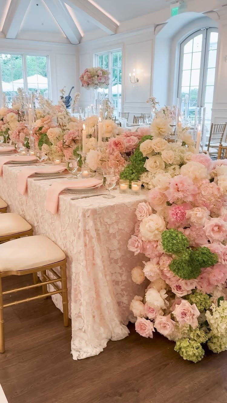 21 Color Combinations for Wedding Palettes in 2026 22 A wedding reception table featuring pink lace linens and lush pink and white floral arrangements.