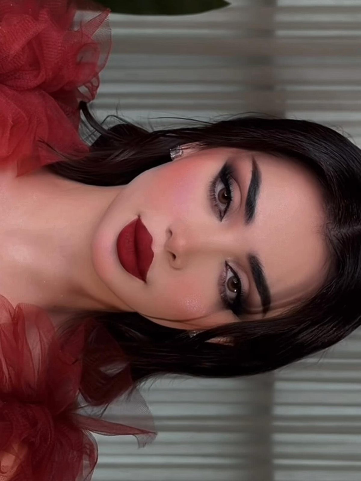 12 Dark Red Wedding Theme Ideas With Floral, Cake and Gown Picks 8 Woman with dark hair wearing dramatic red lipstick and smoky eye makeup.