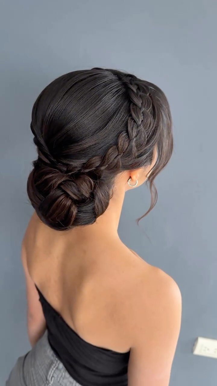 10 Easy Updos for Medium Hair for Wedding Guest Season 2026 5 Woman with dark hair styled in a thick side braid and a low textured bun.