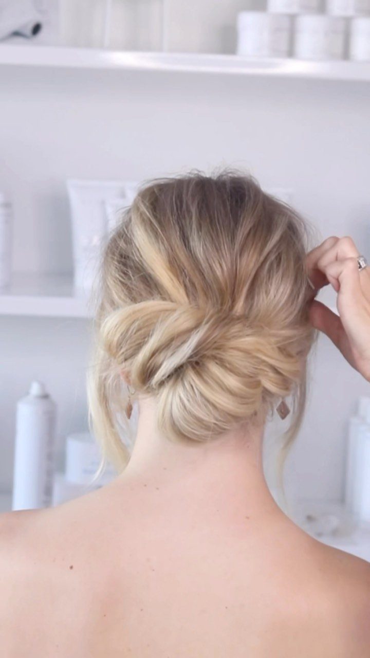 10 Easy Updos for Medium Hair for Wedding Guest Season 2026 2 Blonde woman with her hair styled in a low, textured chignon updo.