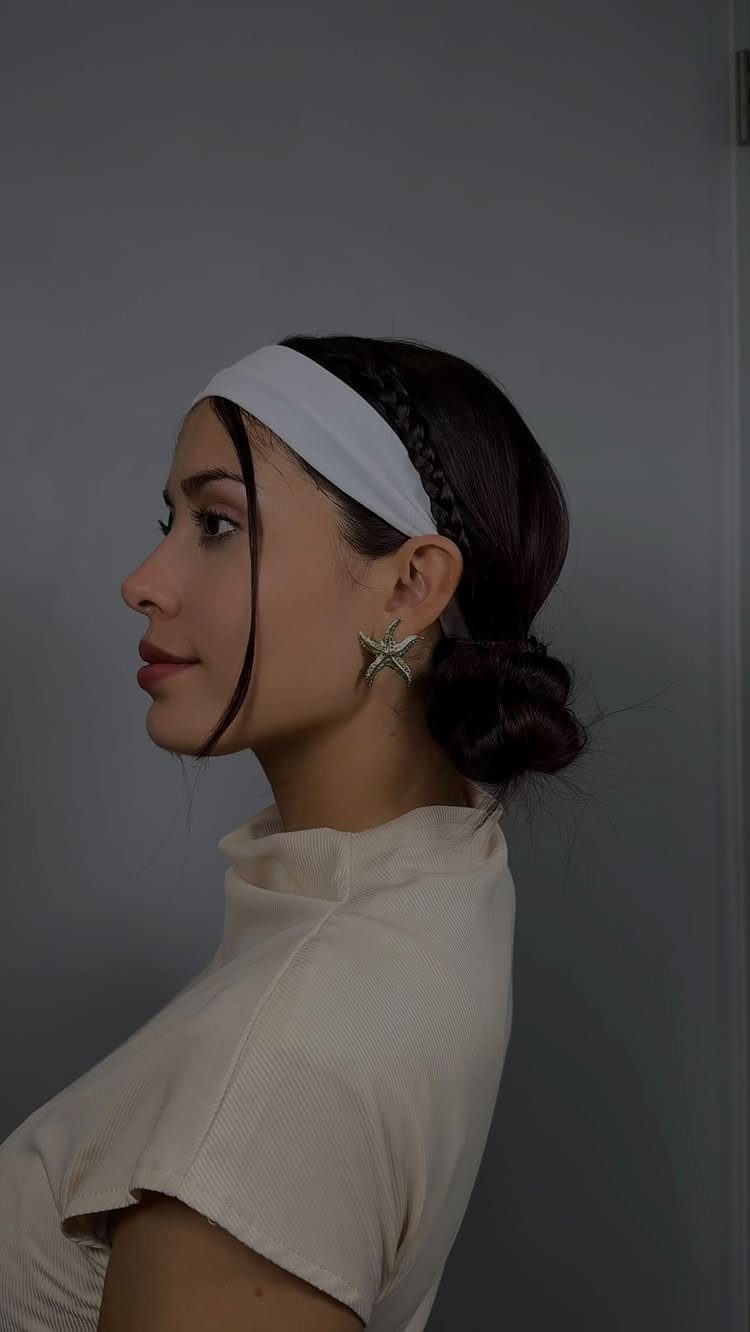10 Easy Updos for Medium Hair for Wedding Guest Season 2026 11 Woman with dark hair in a low bun wearing a wide white headband.
