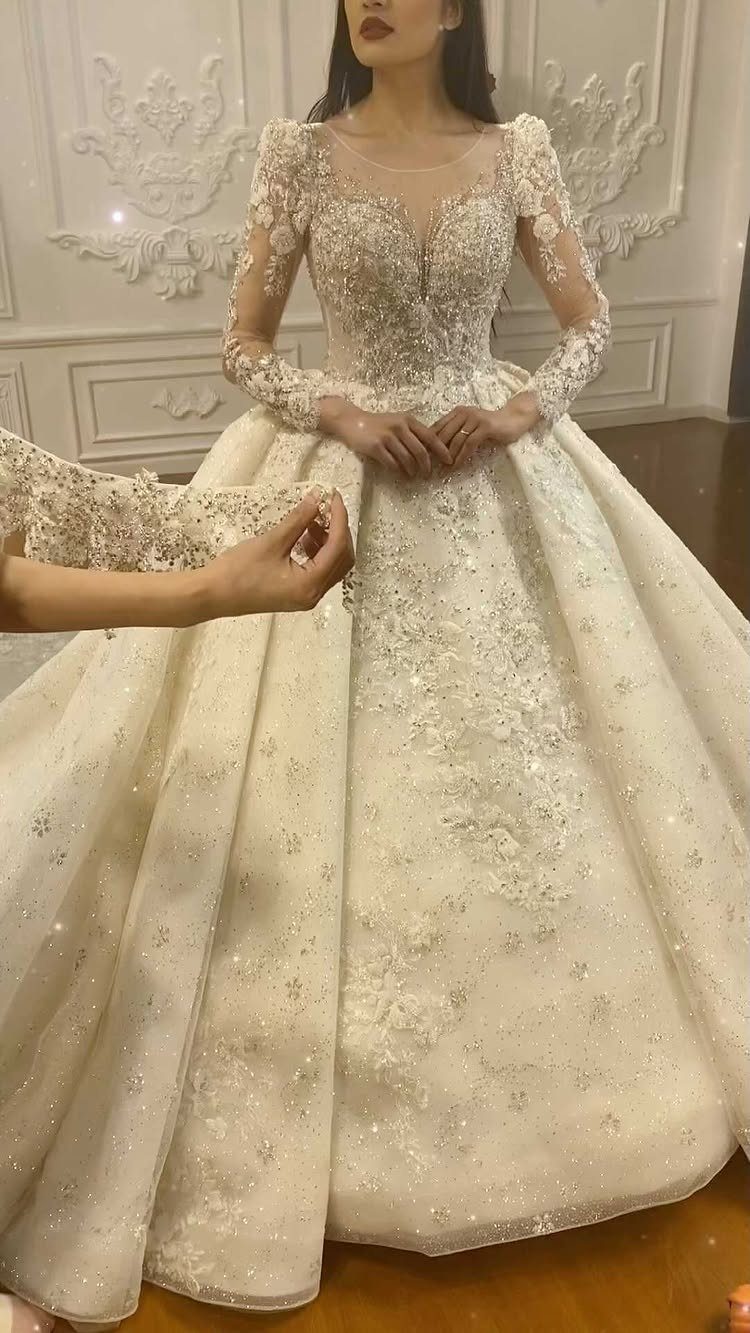 Elegant Princess Wedding Dress Styles in 27 Ideas 4 Woman in a white princess wedding dress with intricate lace details and long sleeves.