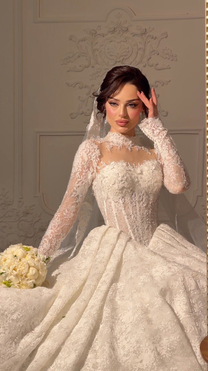 Elegant Princess Wedding Dress Styles in 27 Ideas 25 Woman in a white lace princess wedding dress with a full skirt and veil.
