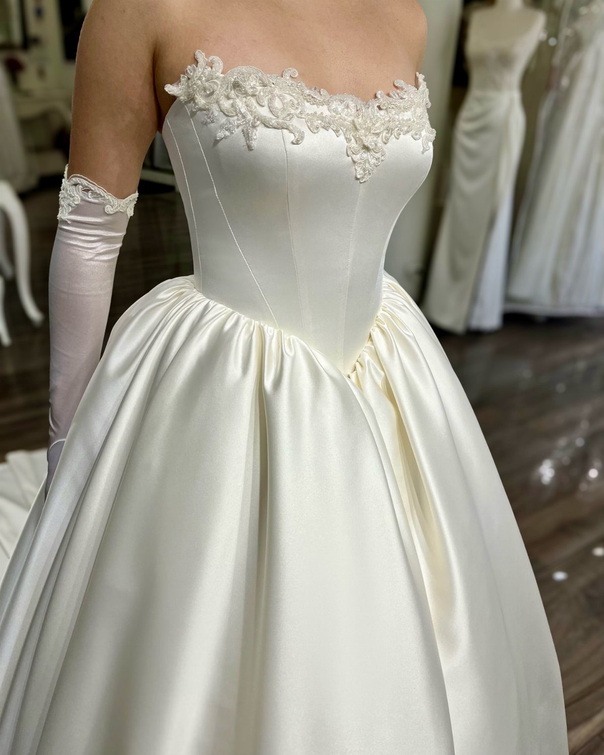 Elegant Princess Wedding Dress Styles in 27 Ideas 10 White satin wedding dress with a full skirt and lace bodice detailing.