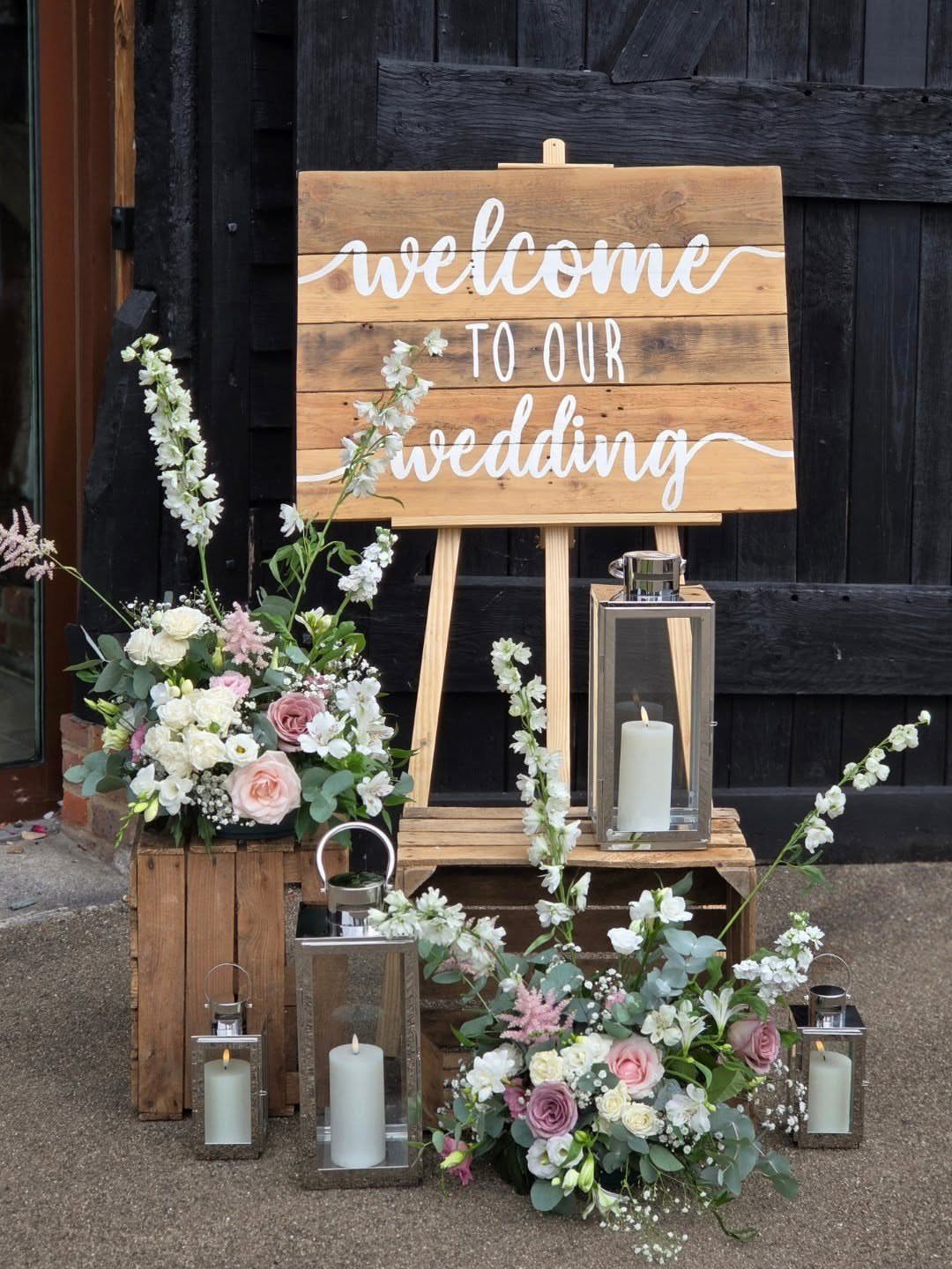 Enchanted Forest Theme Wedding: 12 Ideas for the Ceremony and Reception 4 Wooden wedding welcome sign on an easel surrounded by flowers and lanterns.