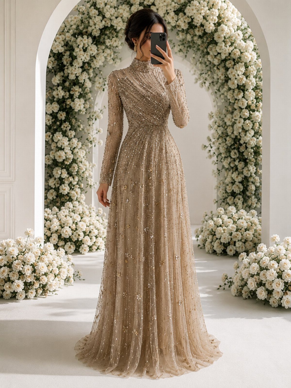 Woman in a shimmering champagne sequin gown standing before a white floral arch.