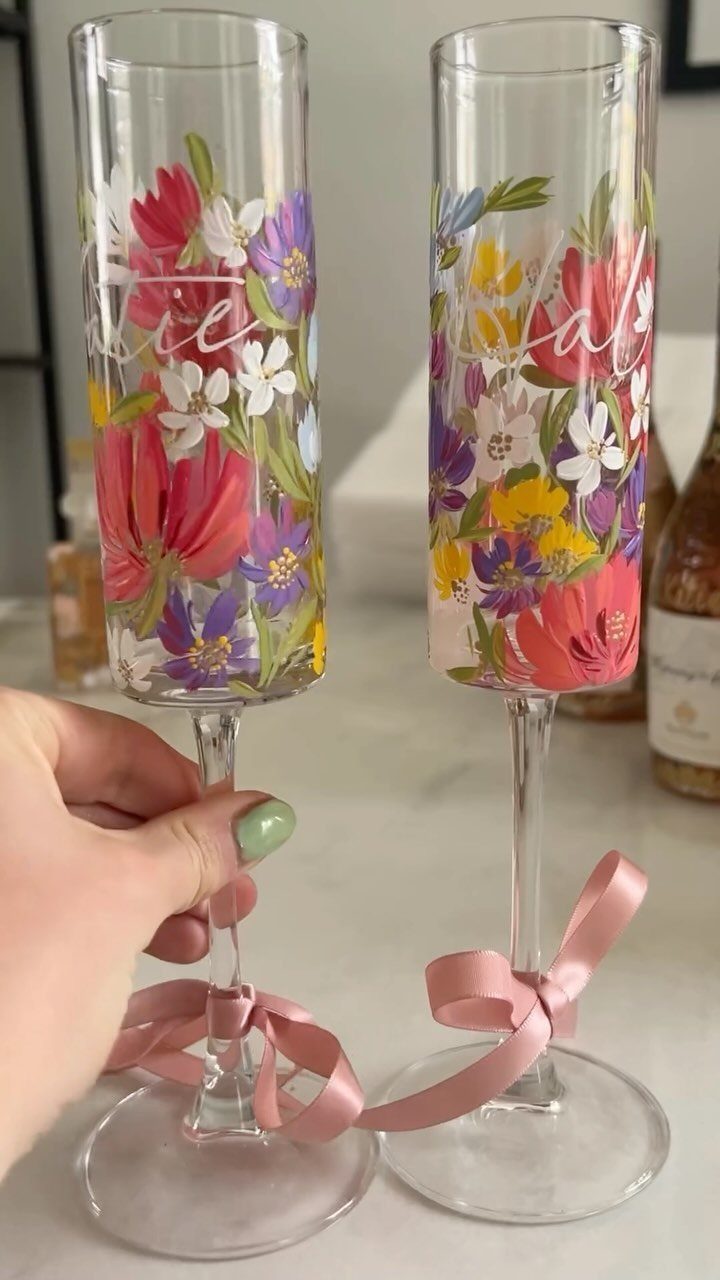 Fantasy Inspired Wedding: 9 Ideas from Forest Photos to Celestial Lace 8 Two champagne flutes with colorful hand-painted floral designs and pink ribbons tied around the stems.