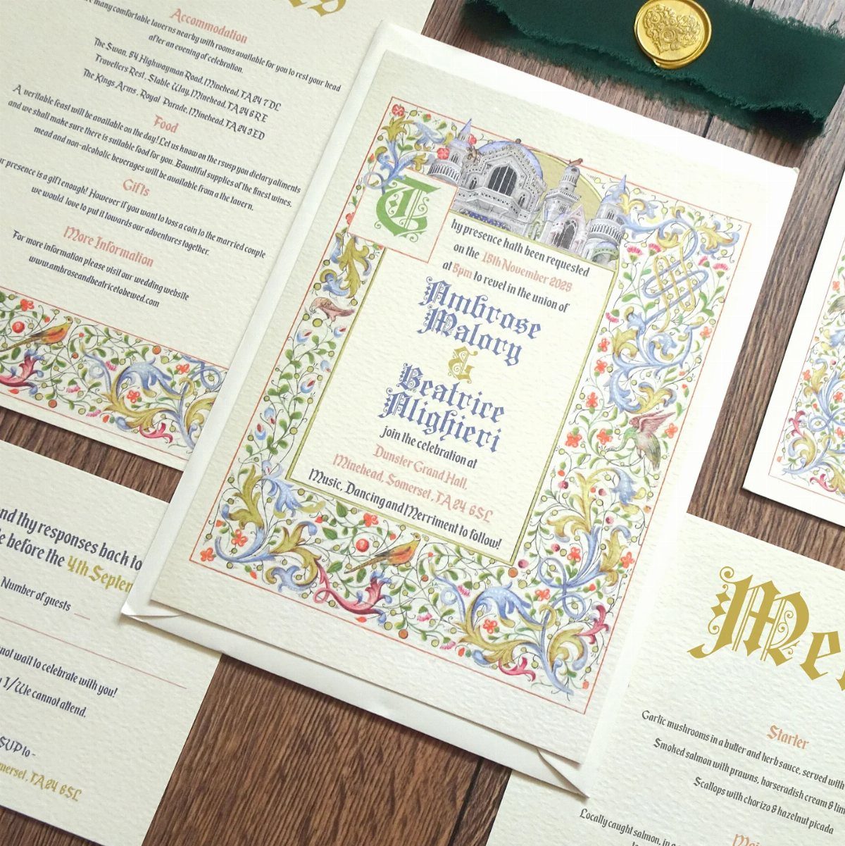 Fantasy Wedding Ideas: 9 Decor, Attire and Theme Details for 2026 5 Medieval style wedding invitations with colorful floral borders and calligraphy on a wooden table.