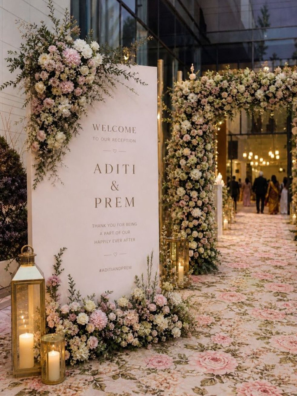 Flowers for Wedding Reception: 11 Elegant Ideas to Style Your Space 5 Welcome sign and floral arch at a wedding reception entrance with gold lanterns.