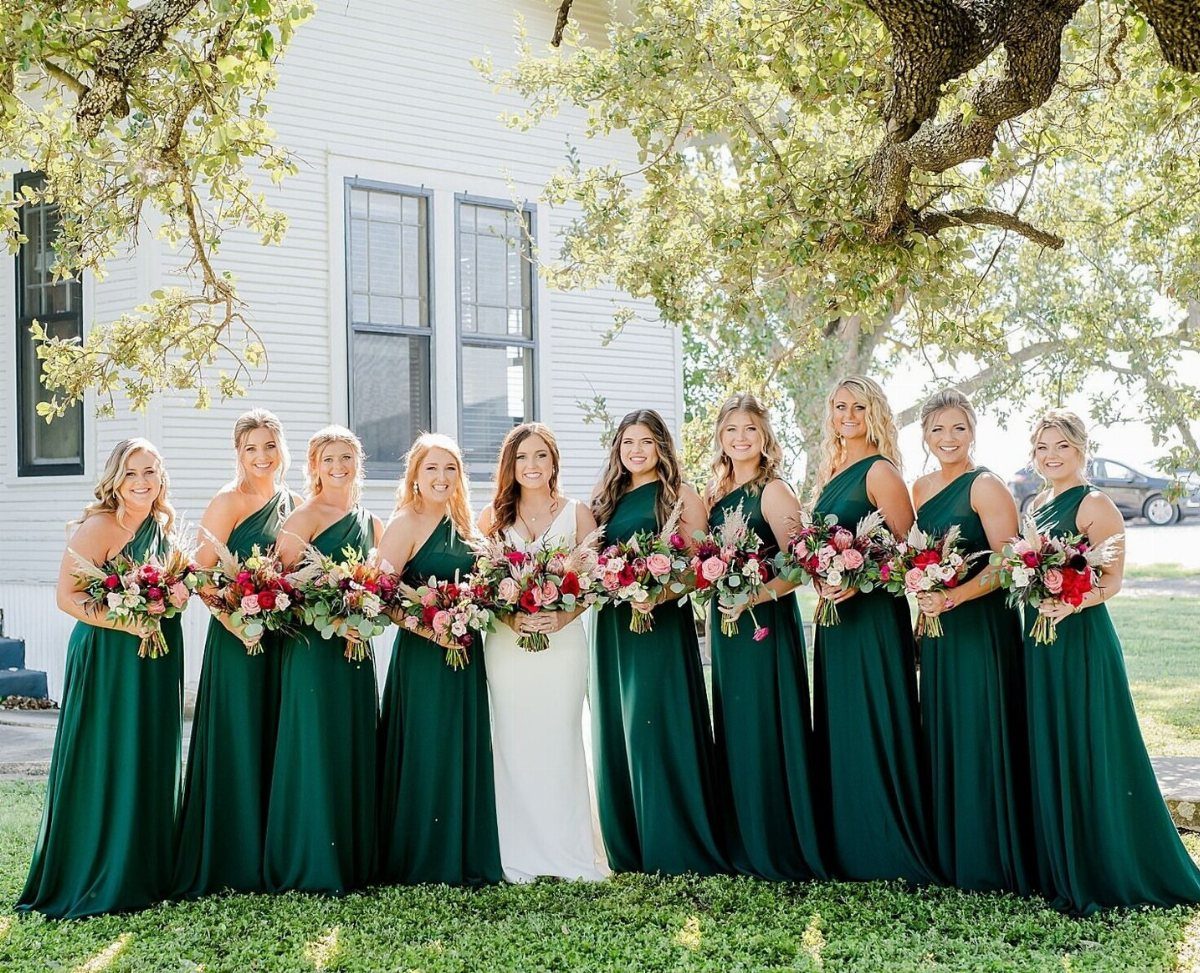 Forest Green for Wedding Colors: 10 Ideas to Try 10 Bridesmaids in long forest green dresses holding floral bouquets standing outdoors with a bride.