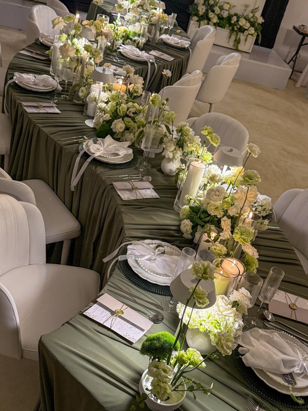Forest Green for Wedding Colors: 10 Ideas to Try 4 A long wedding table with sage green linens and white floral centerpieces.