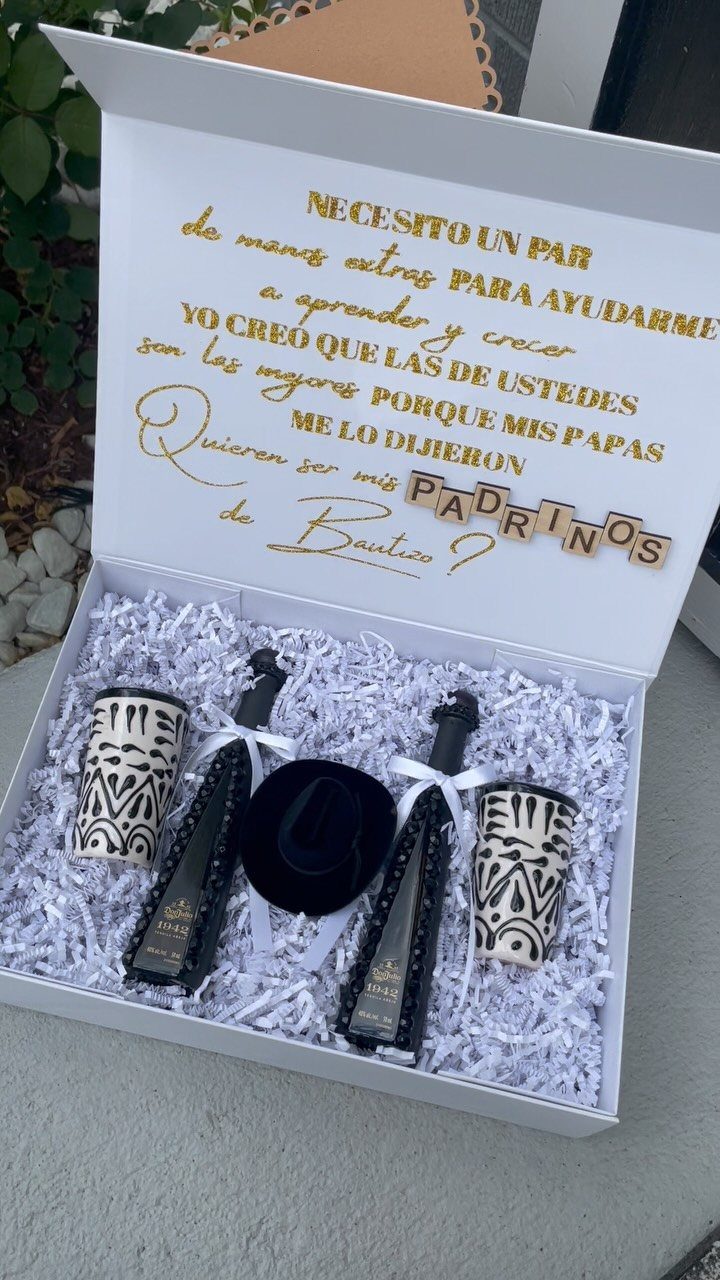 7 Godparent Proposal Box Ideas to Make the Ask Special 4 Cowboy-themed proposal box with black hat, patterned tumblers, and champagne bottles.