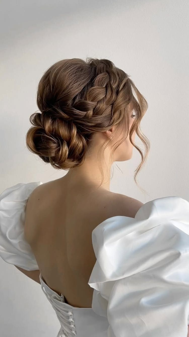 18 Hoco Updo Hairstyles From Braids to Sleek Buns 17 Woman with light brown hair styled in an intricate braided bun hairstyle.