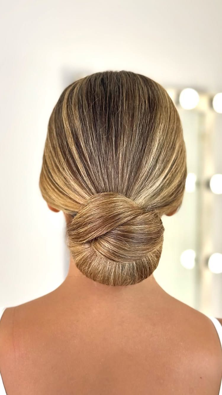 18 Hoco Updo Hairstyles From Braids to Sleek Buns 18 Blonde hair styled in a smooth, sleek low bun at the nape of the neck.