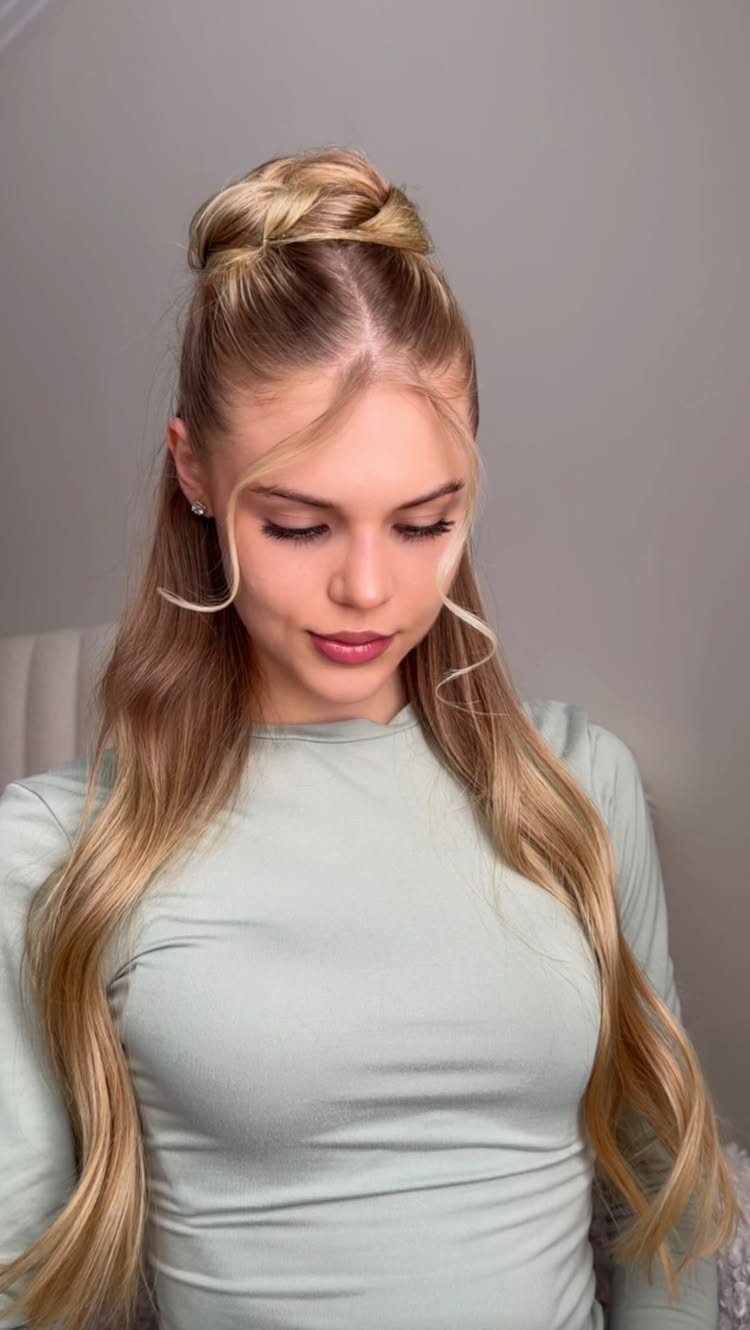16 Long Hair Half Up Half Down Hairstyles for Real Life 6 A blonde woman with long wavy hair styled in a half-up high bun.
