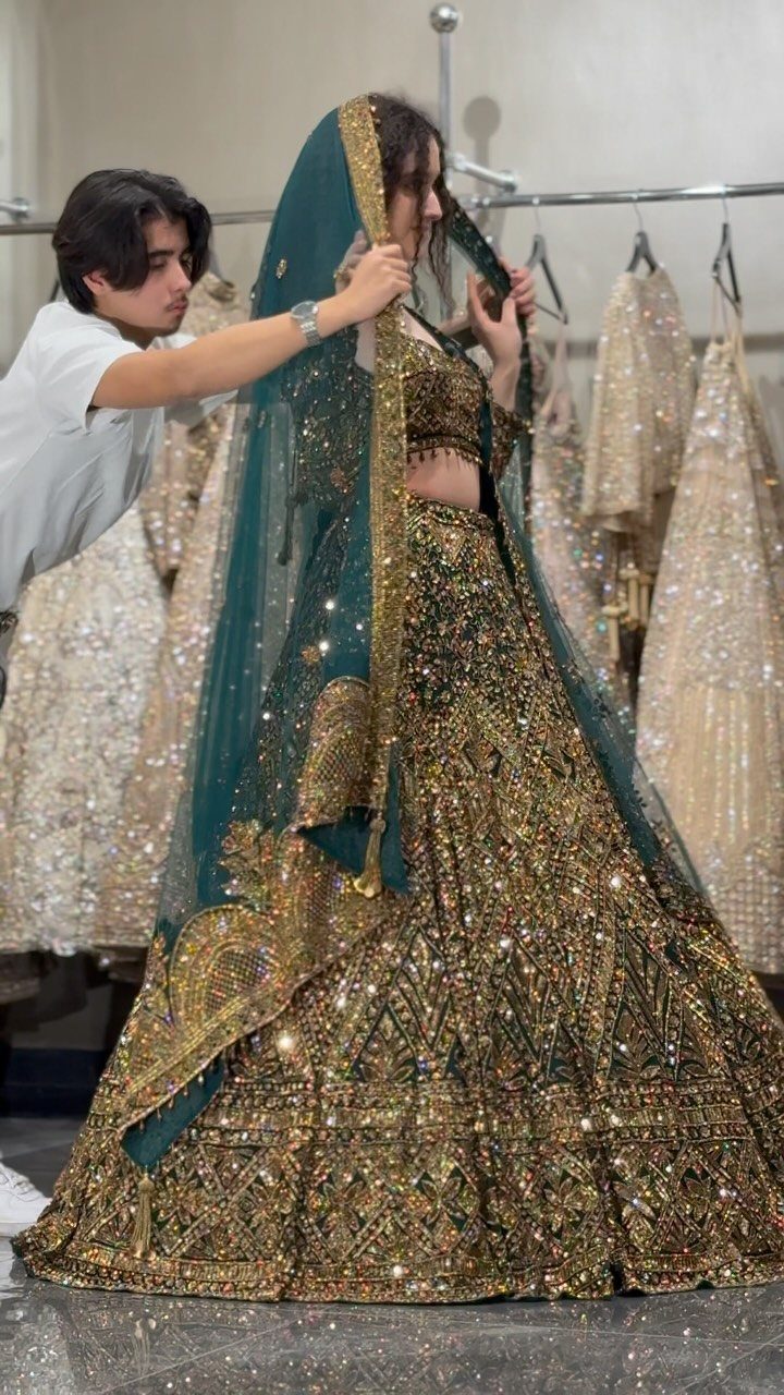 26 Nikah Dress Ideas for Your Perfect Wedding Ceremony 21 Woman in an emerald green and gold embellished lengha with a matching dupatta.
