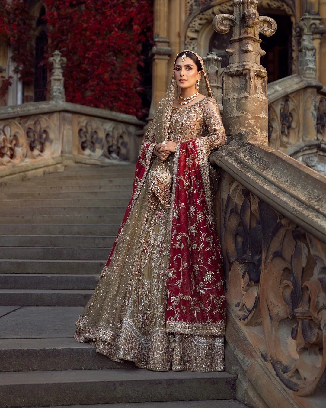 26 Nikah Dress Ideas for Your Perfect Wedding Ceremony 4 Woman in a gold embellished bridal lehenga with a red embroidered dupatta.
