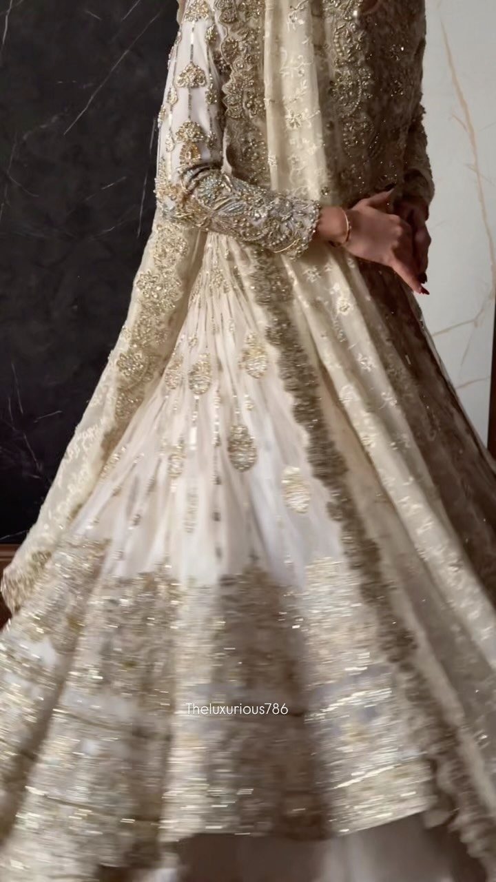 26 Nikah Dress Ideas for Your Perfect Wedding Ceremony 24 Ivory and gold embellished bridal gown with intricate embroidery and a flared skirt.
