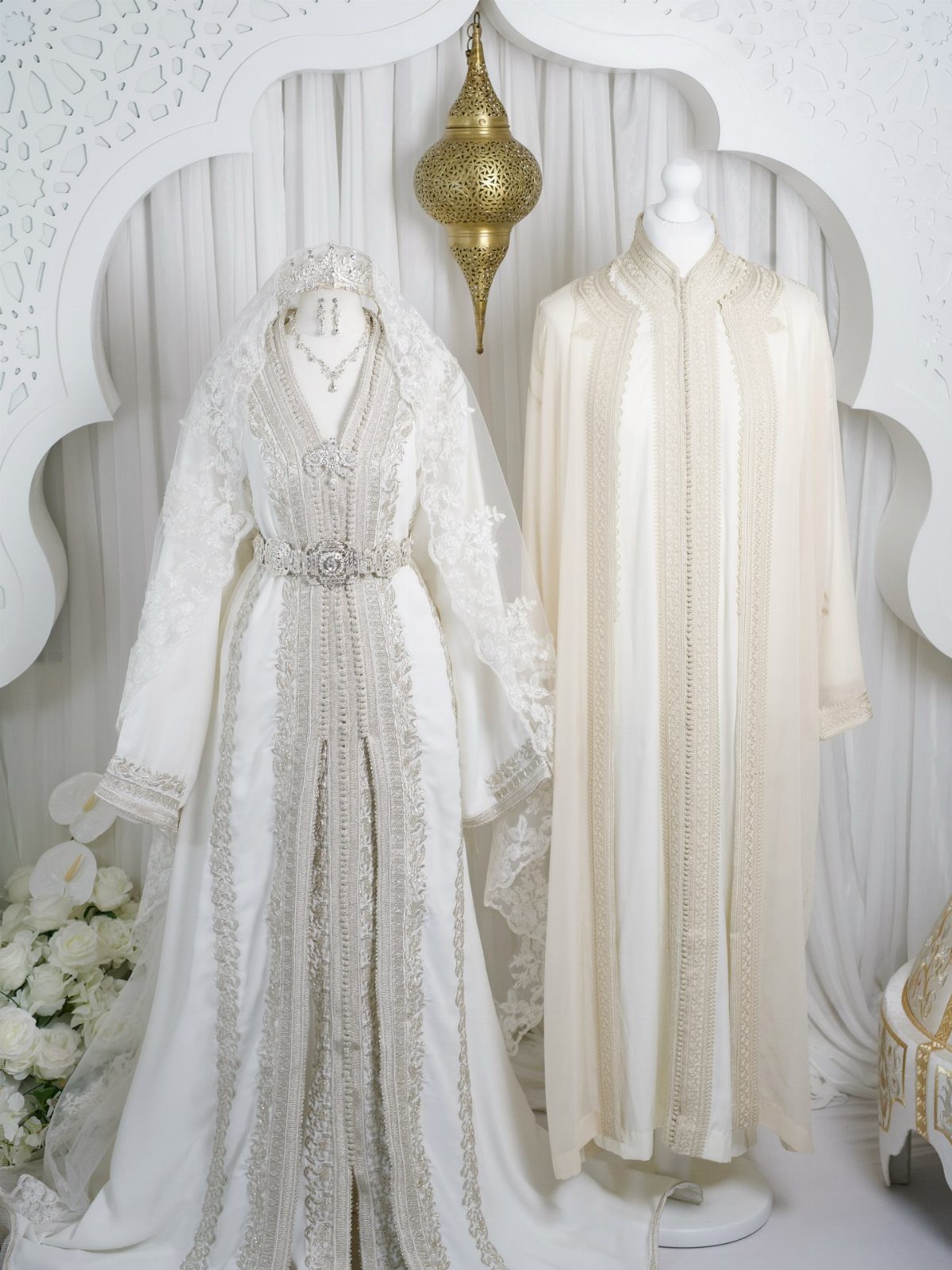 26 Nikah Dress Ideas for Your Perfect Wedding Ceremony 19 Two white bridal gowns, one embellished and one kaftan style, on white mannequins.