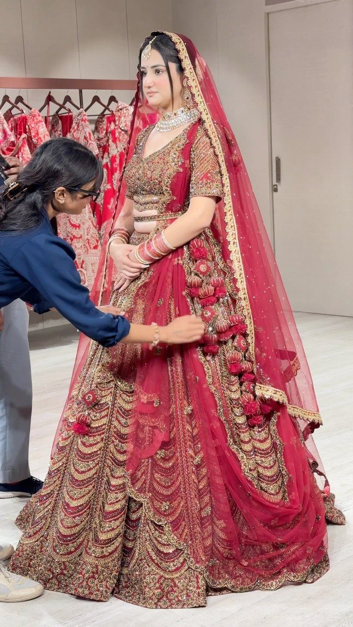 26 Nikah Dress Ideas for Your Perfect Wedding Ceremony 2 Woman in a red lengha with gold embroidery and a matching red dupatta.