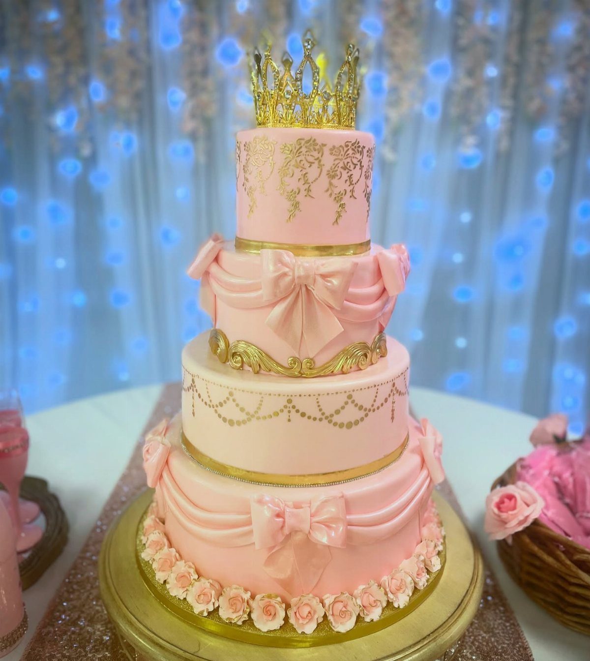 Quince Cake Ideas: 18 Designs From Florals to Butterflies 8 Multi-tiered pink cake with gold crown, gold filigree, and large edible pink bows.