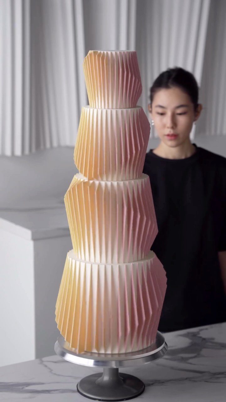 Quince Cake Ideas: 18 Designs From Florals to Butterflies 12 Four-tier cake with pleated geometric texture in a yellow to pink gradient.