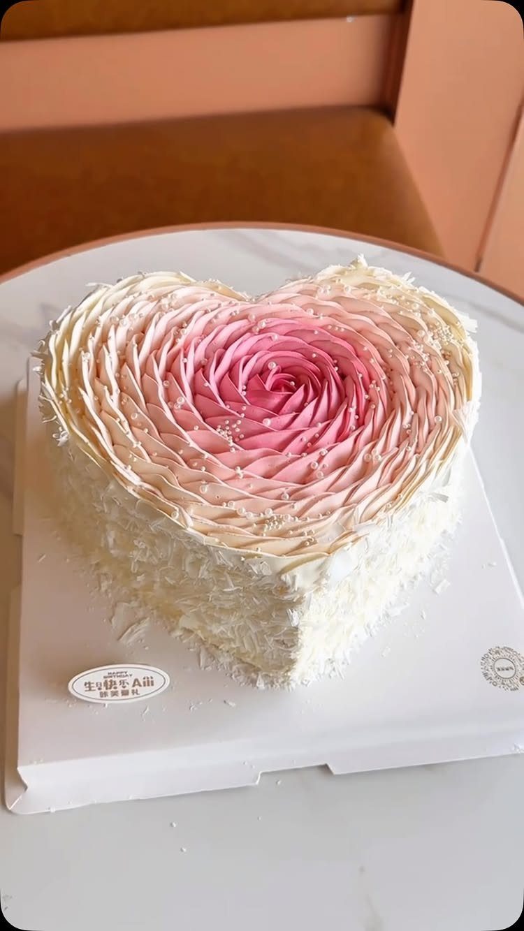 Quince Cake Ideas: 18 Designs From Florals to Butterflies 11 Heart-shaped cake with white frosting and a pink ombré rose petal design on top.