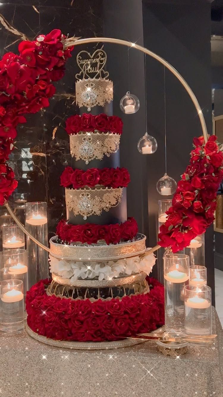 38 Romantic Wedding Cake Ideas for Your Celebration 24 Multi-tiered black and gold wedding cake decorated with red roses and gold lace.