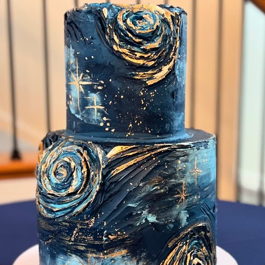 38 Romantic Wedding Cake Ideas for Your Celebration 29 Two-tier dark blue cake with gold cosmic swirls and sparkling stars.
