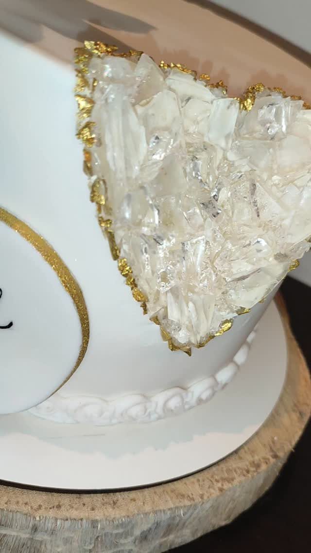 38 Romantic Wedding Cake Ideas for Your Celebration 38 White cake with a heart-shaped geode cutout filled with translucent crystals and gold leaf.