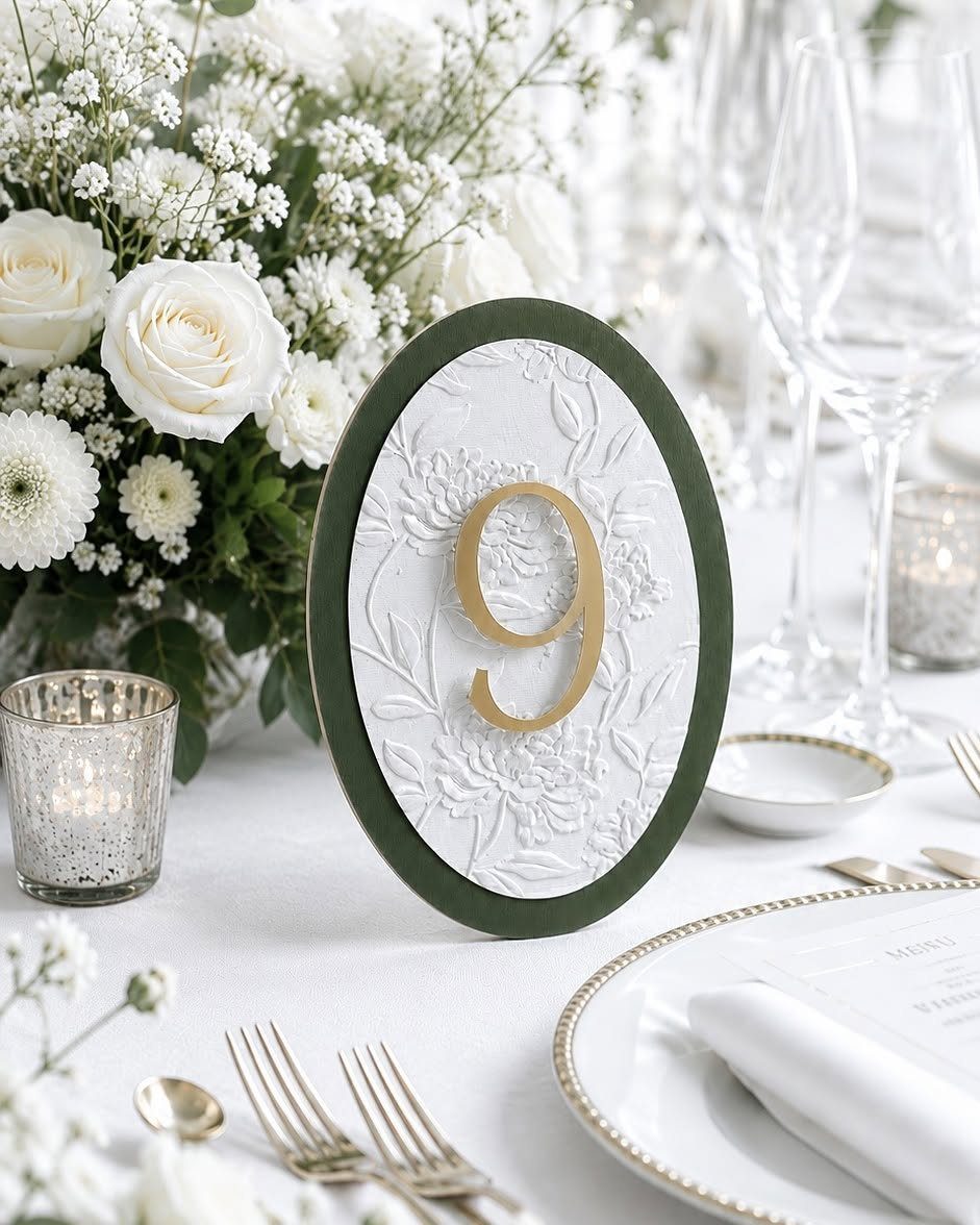 13 Round Table Wedding Decor Ideas: From S-Curved Layouts to Draped Florals 9 An oval green and white floral table number sign displaying a gold number nine.