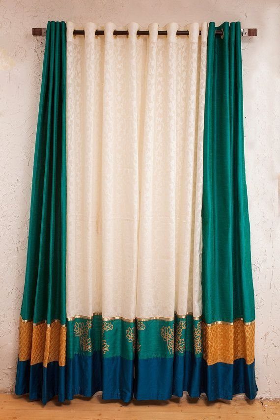Saree fabric curtains with white and teal panels and gold decorative borders.