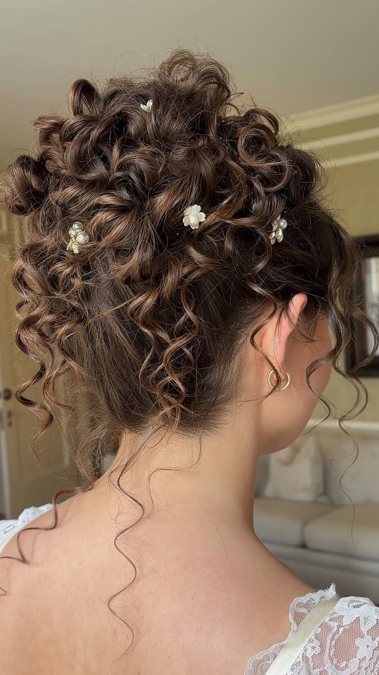 9 Short Curly Hairstyles for Wedding Day Perfection 8 Short curly brown hair styled in a wedding updo with white floral pins.