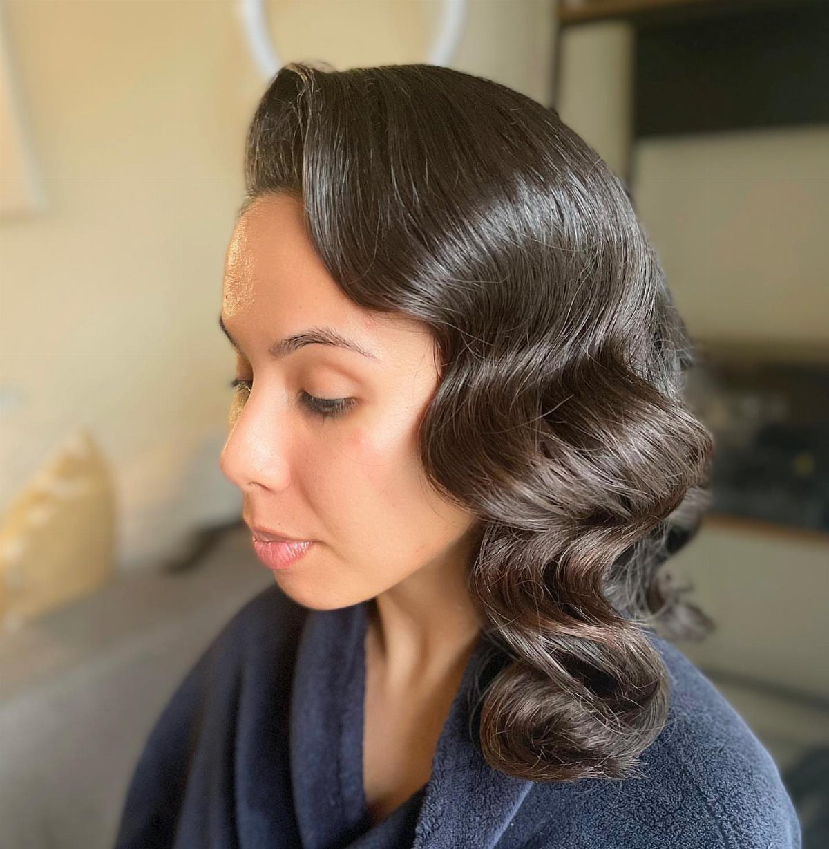 9 Short Curly Hairstyles for Wedding Day Perfection 2 Woman with dark brown hair styled in polished, vintage Hollywood waves.