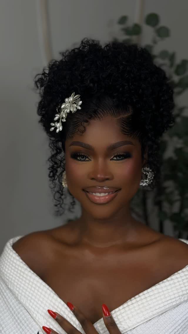 9 Short Curly Hairstyles for Wedding Day Perfection 9 Woman with short curly black hair and silver floral accessory wearing white robe