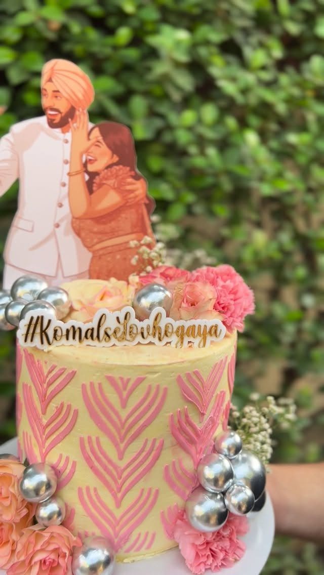 Sister Wedding Gift Ideas: 34 Picks She'll Treasure 28 Yellow wedding cake with pink frosting patterns and a custom couple cake topper.