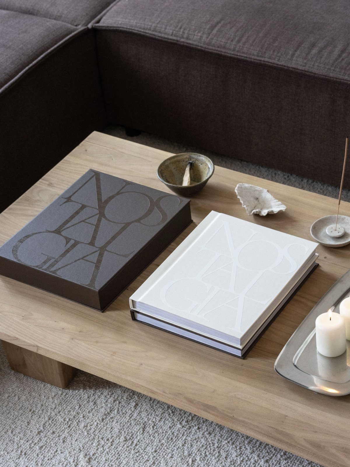 Sister Wedding Gift Ideas: 34 Picks She'll Treasure 23 Two large hardcover coffee table books on a light wooden table with decor.