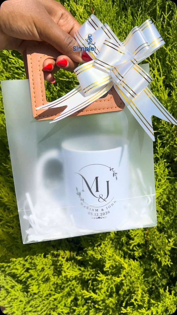 Sister Wedding Gift Ideas: 34 Picks She'll Treasure 18 White personalized wedding coffee mug inside a frosted gift bag with a gold bow.