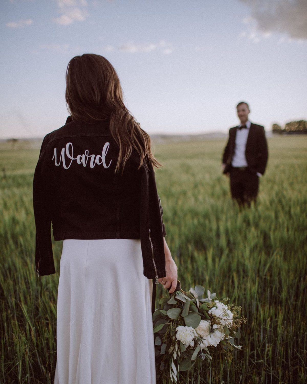 Sister Wedding Gift Ideas: 34 Picks She'll Treasure 26 Woman in white dress wearing a black leather jacket with Ward written on back.