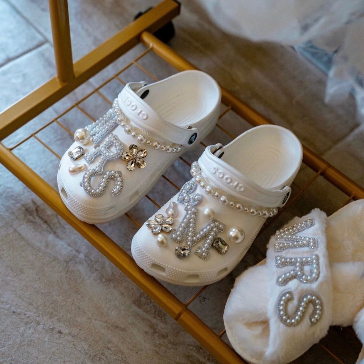 Sister Wedding Gift Ideas: 34 Picks She'll Treasure 15 White bridal slippers and Crocs decorated with pearls and rhinestones spelling MRS.