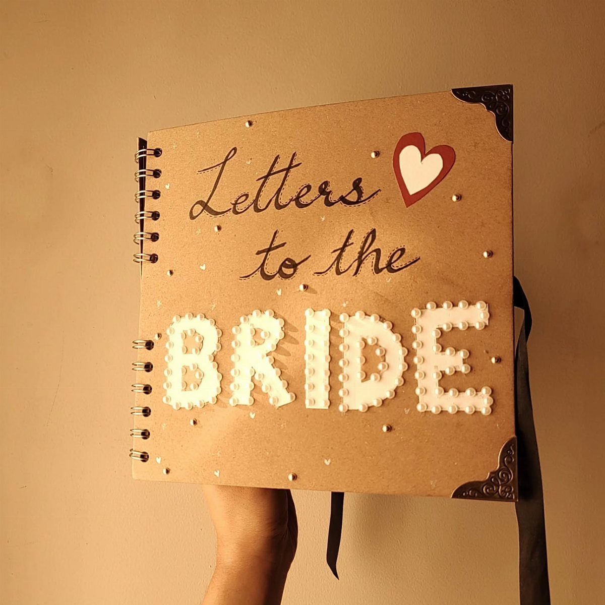Sister Wedding Gift Ideas: 34 Picks She'll Treasure 29 Brown spiral notebook with pearl lettering that says Letters to the Bride.